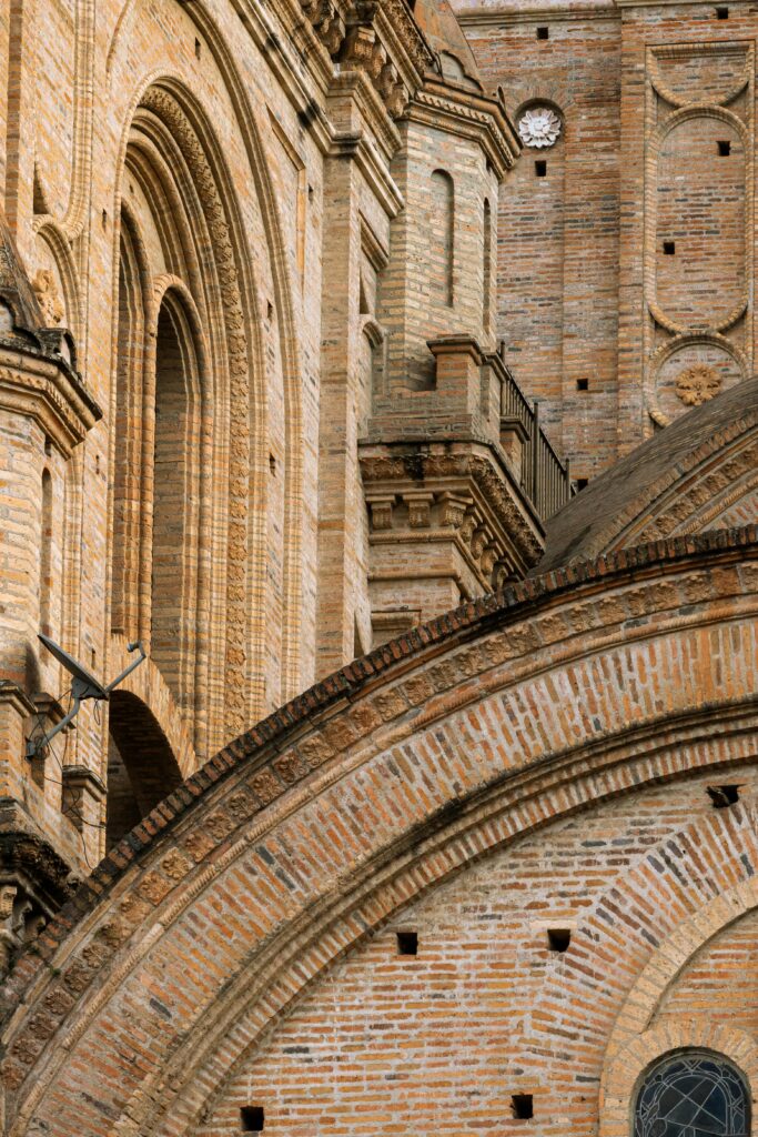 A detailed view of the medieval-style brickwork on Cuenca Cathedral, Ecuador.